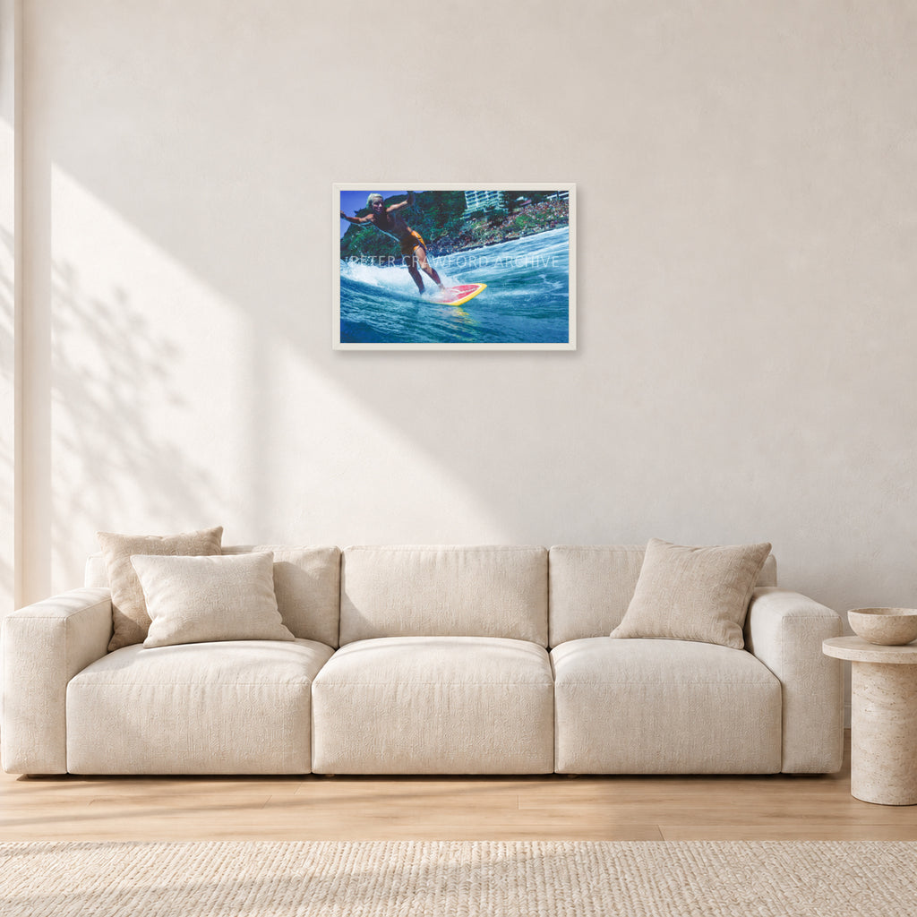 Cheyne Horan, Stubbies 1978 by Peter Crawford — 60 × 40 cm, white frame, shown in a light minimalist living room.