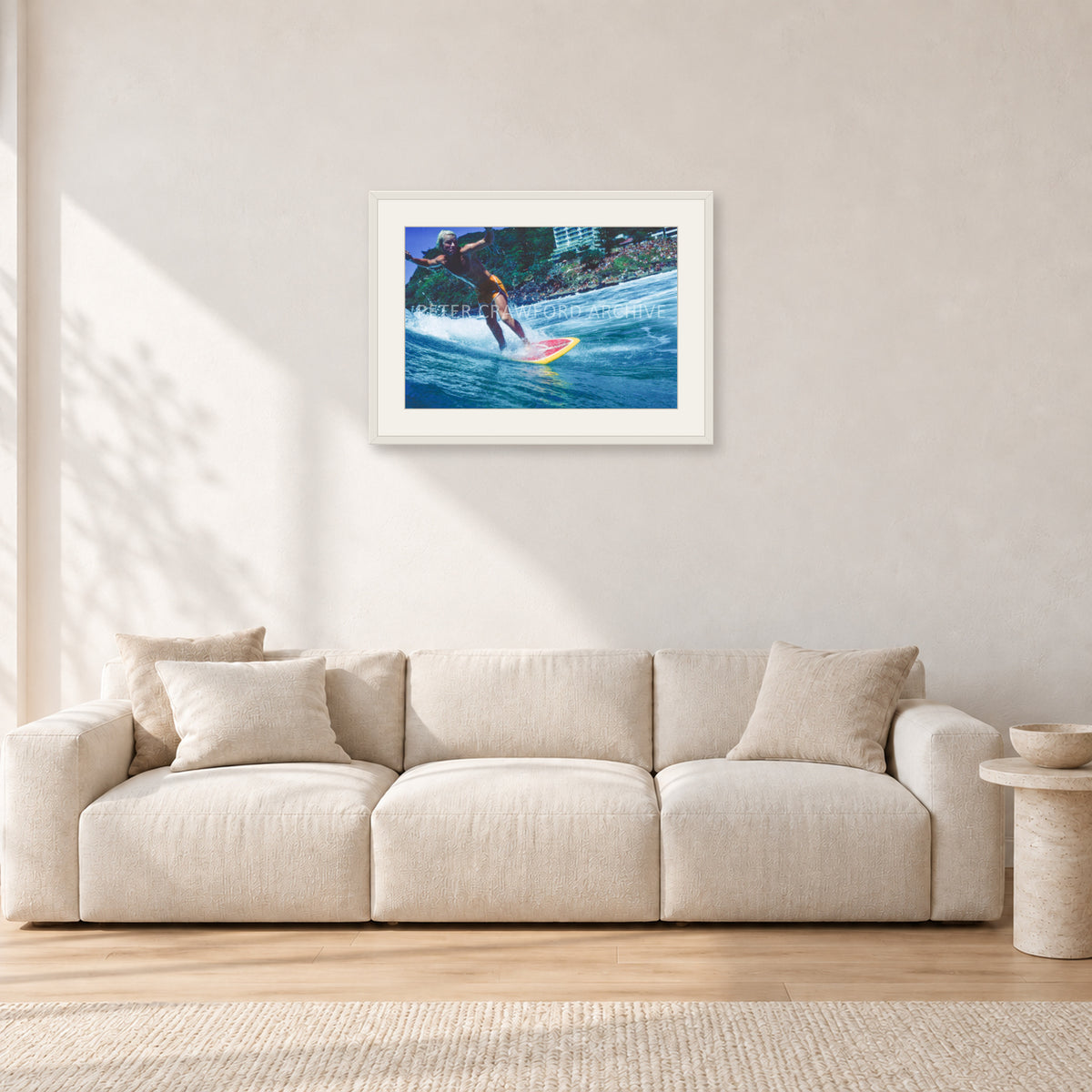 Cheyne Horan, Stubbies 1978 by Peter Crawford — 60 × 40 cm, white frame with white mat, shown in a light minimalist living room.