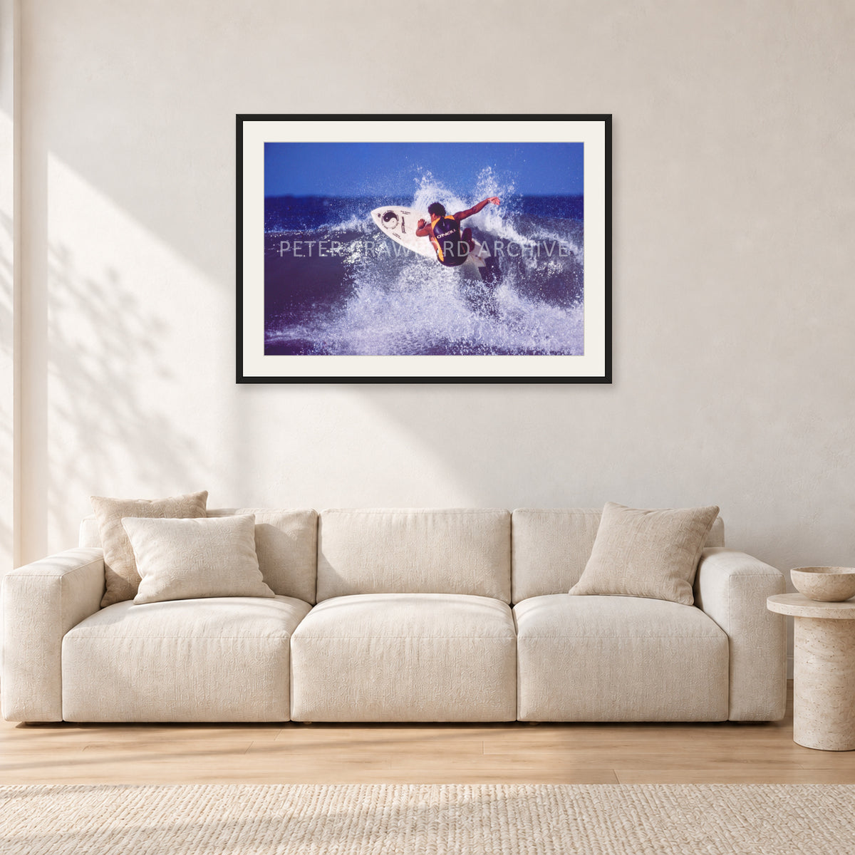 Dane Kealoha, Off The Wall 1977 by Peter Crawford — 90 × 60 cm, black frame with white mat, shown in a light minimalist living room.