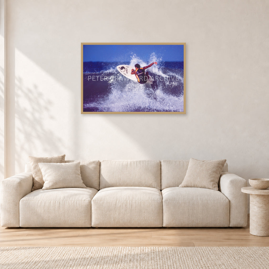 Dane Kealoha, Off The Wall 1977 by Peter Crawford — 90 × 60 cm, hayseed frame, shown in a light minimalist living room.