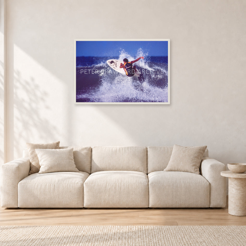 Dane Kealoha, Off The Wall 1977 by Peter Crawford — 90 × 60 cm, white frame, shown in a light minimalist living room.