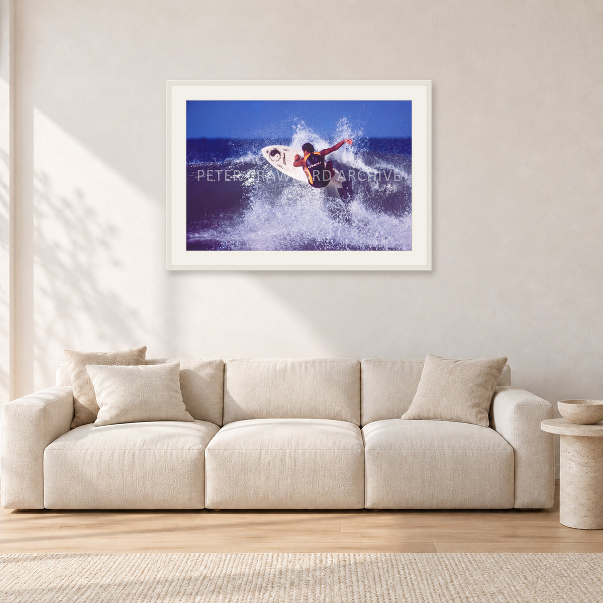 Dane Kealoha, Off The Wall 1977 by Peter Crawford — 90 × 60 cm, white frame with white mat, shown in a light minimalist living room.