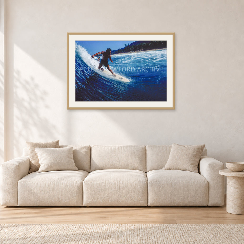 Dane Kealoha, Off The Wall 1978 by Peter Crawford — 90 × 60 cm, hayseed frame with white mat, shown in a light minimalist living room.