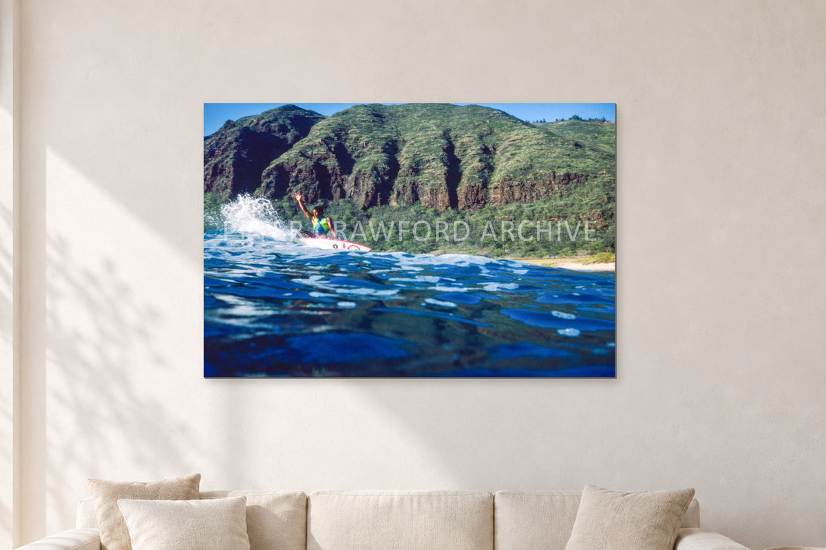Dane Kealoha, West Side Oahu by Peter Crawford — 120 × 80 cm, aluminium-mounted resin print, shown in a light minimalist living room.