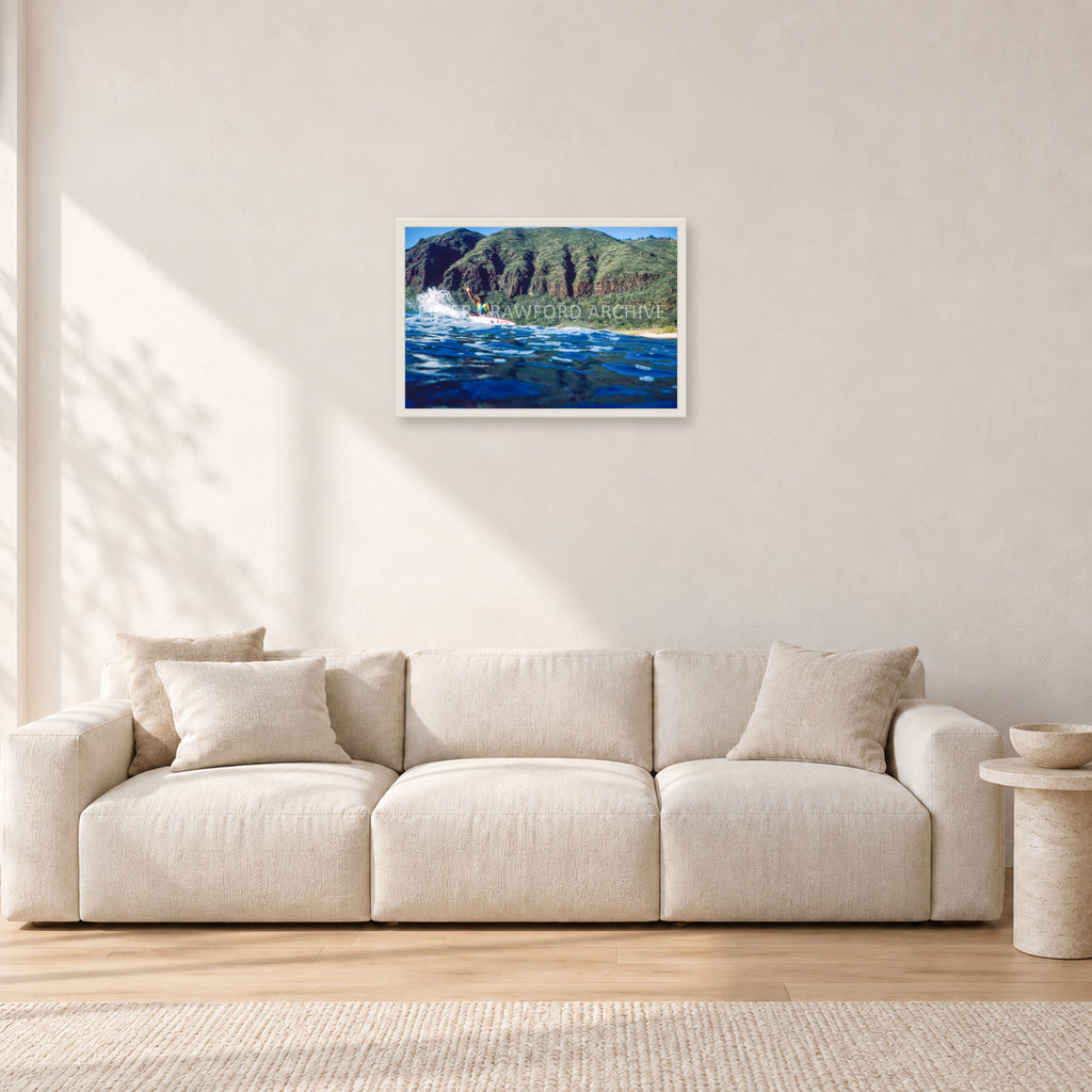 Dane Kealoha, West Side Oahu by Peter Crawford — 60 × 40 cm, white frame, shown in a light minimalist living room.
