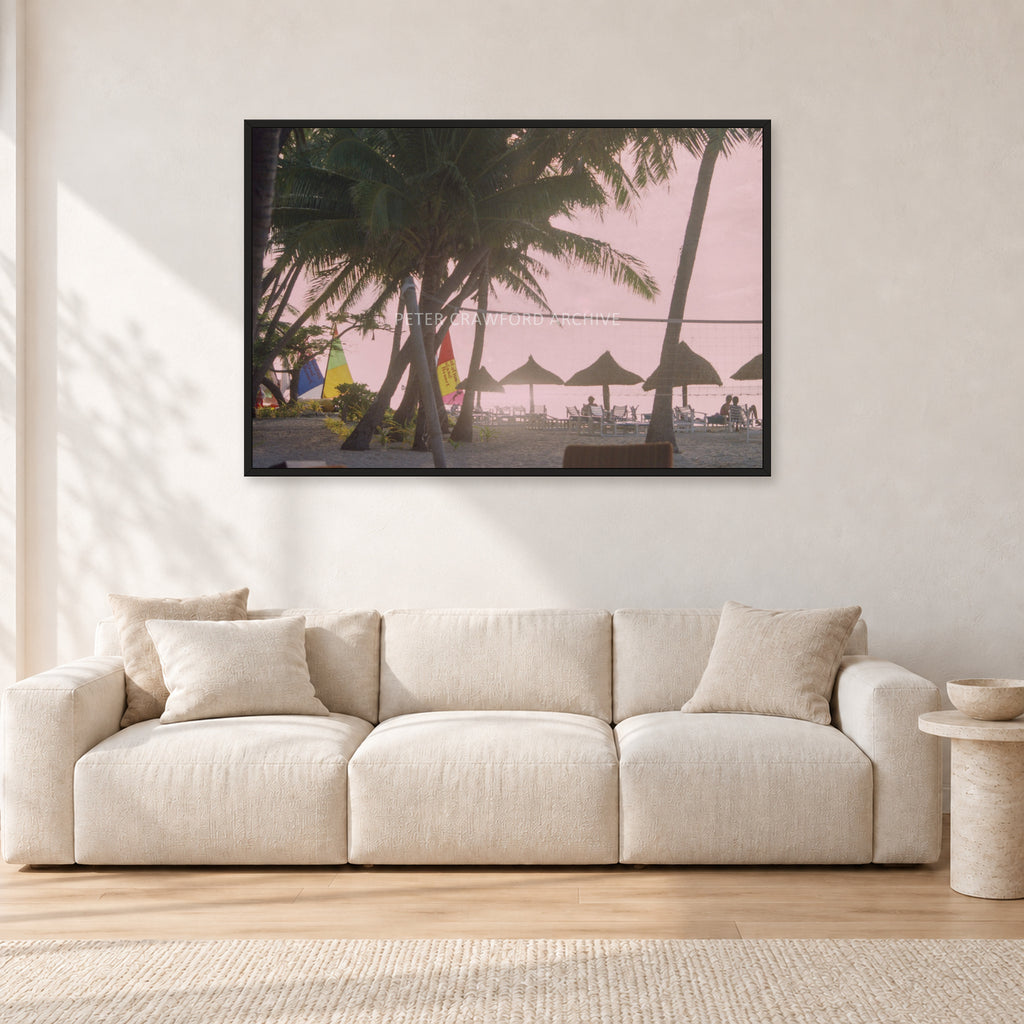 Fiji Sunset I by Peter Crawford — 120 × 80 cm, black frame, shown in a light minimalist living room.