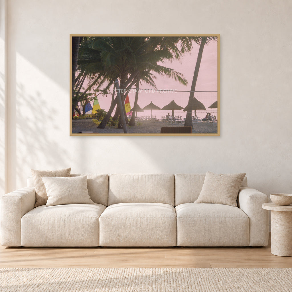 Fiji Sunset I by Peter Crawford — 120 × 80 cm, hayseed frame, shown in a light minimalist living room.