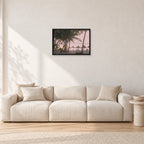 Fiji Sunset I by Peter Crawford — 60 × 40 cm, black frame, shown in a light minimalist living room.