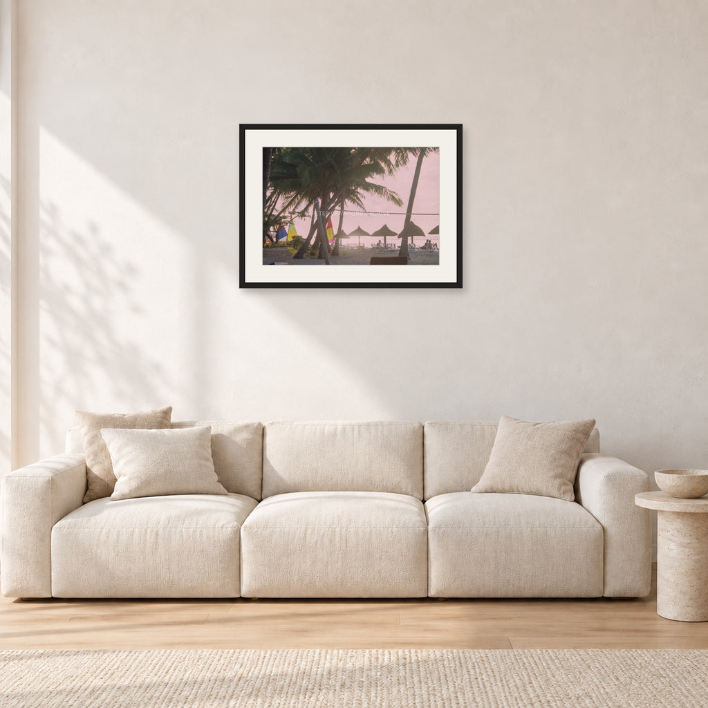 Fiji Sunset I by Peter Crawford — 60 × 40 cm, black frame with white mat, shown in a light minimalist living room.