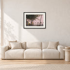 Fiji Sunset I by Peter Crawford — 60 × 40 cm, black frame with white mat, shown in a light minimalist living room.