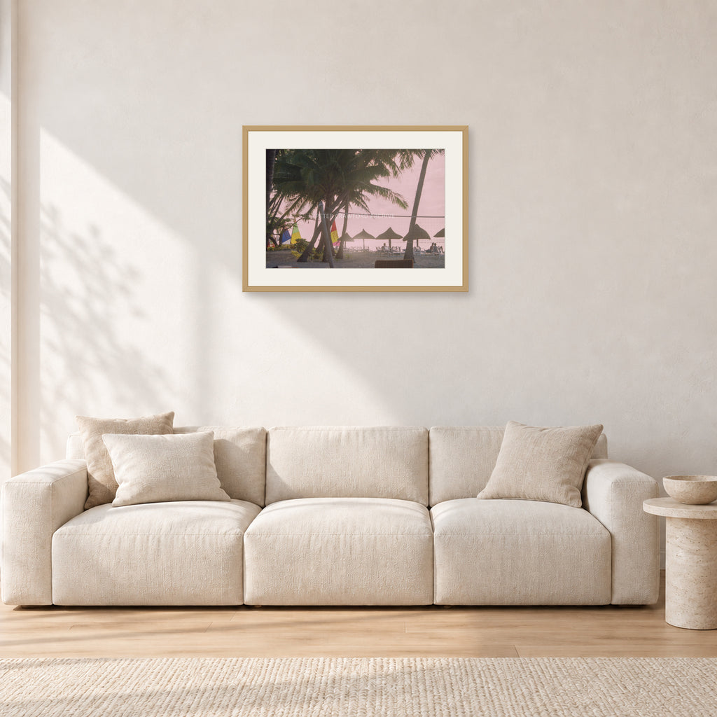 Fiji Sunset I by Peter Crawford — 60 × 40 cm, hayseed frame with white mat, shown in a light minimalist living room.