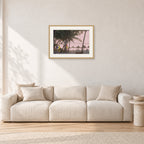 Fiji Sunset I by Peter Crawford — 60 × 40 cm, hayseed frame with white mat, shown in a light minimalist living room.