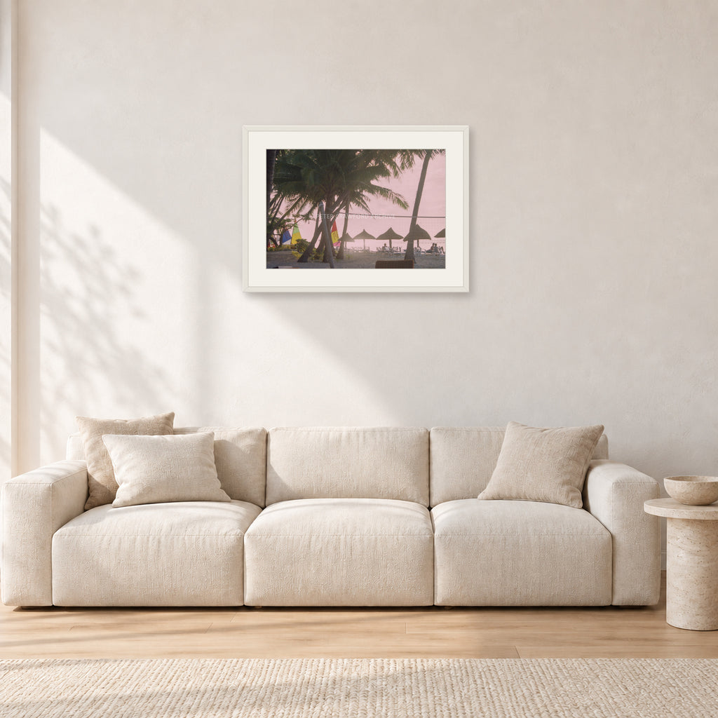 Fiji Sunset I by Peter Crawford — 60 × 40 cm, white frame with white mat, shown in a light minimalist living room.