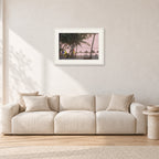 Fiji Sunset I by Peter Crawford — 60 × 40 cm, white frame with white mat, shown in a light minimalist living room.
