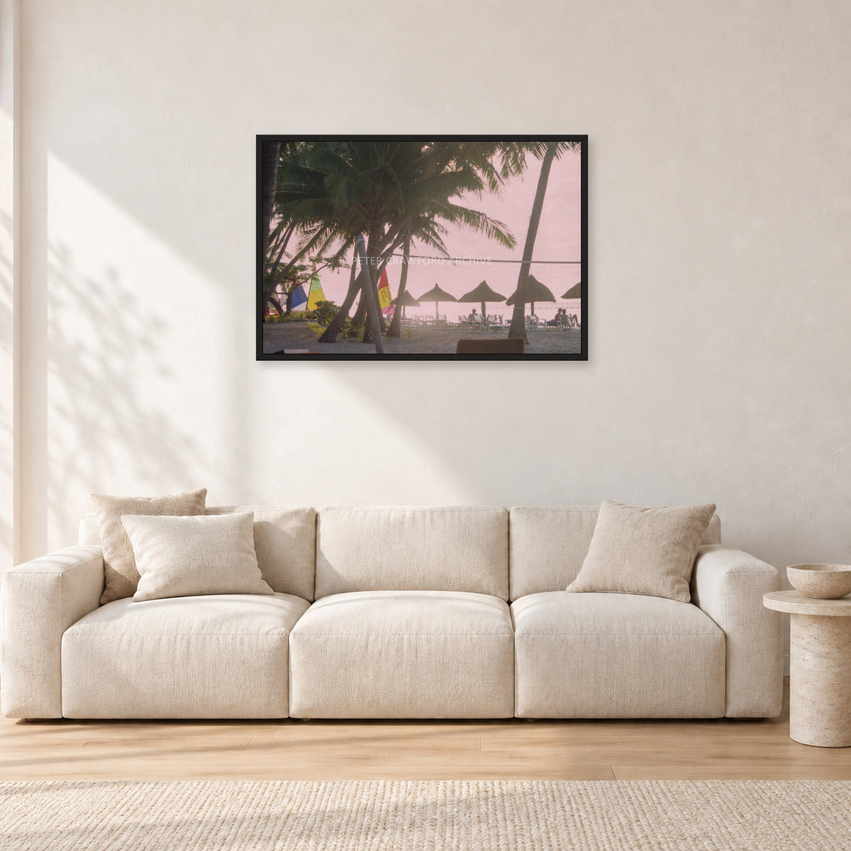 Fiji Sunset I by Peter Crawford — 90 × 60 cm, black frame, shown in a light minimalist living room.
