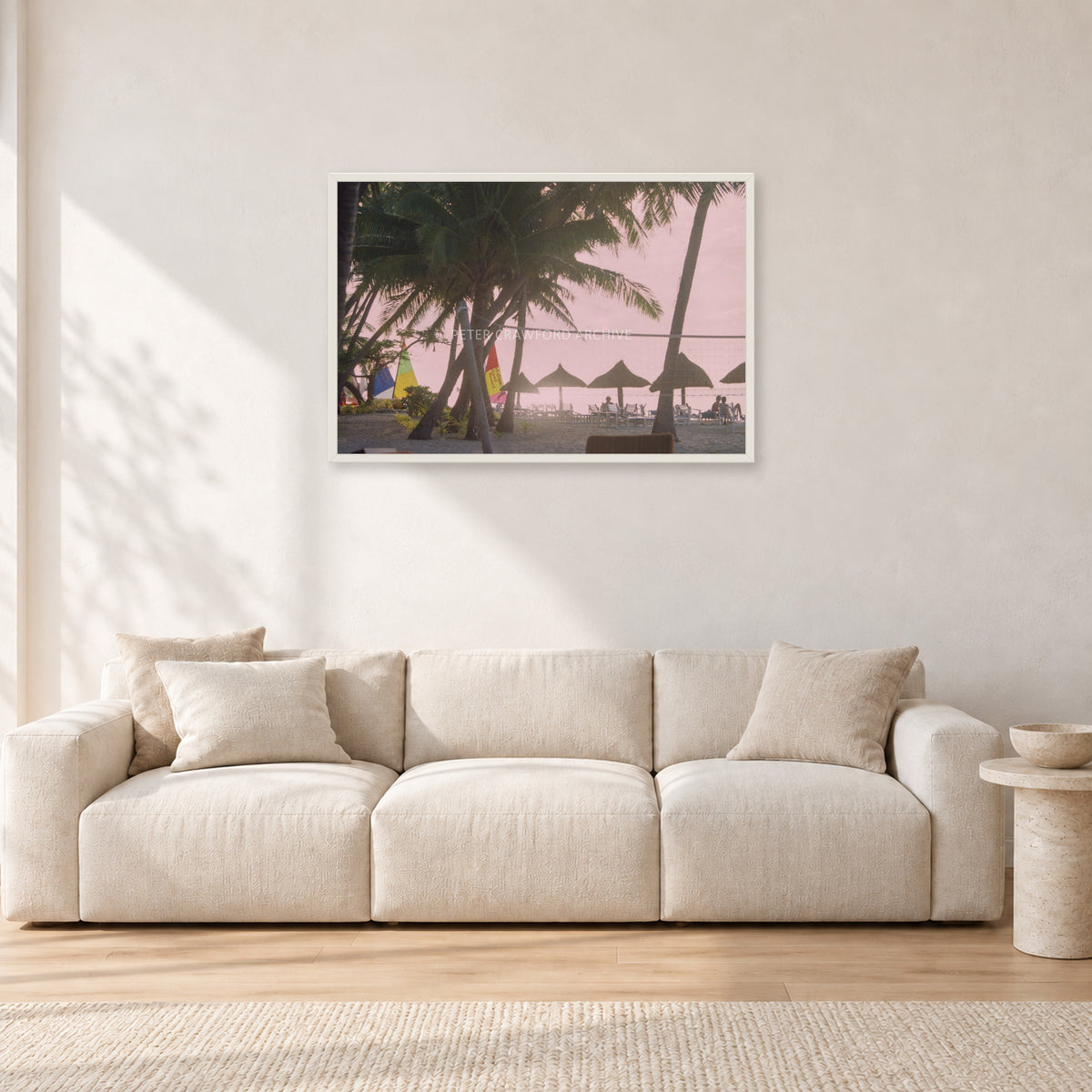 Fiji Sunset I by Peter Crawford — 90 × 60 cm, white frame, shown in a light minimalist living room.