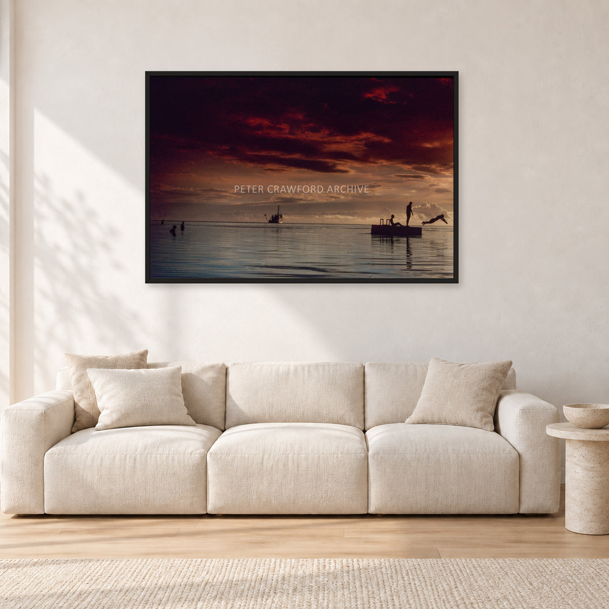 Fiji Sunset II by Peter Crawford — 120 × 80 cm, black frame, shown in a light minimalist living room.