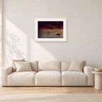 Fiji Sunset II by Peter Crawford — 60 × 40 cm, white frame with white mat, shown in a light minimalist living room.