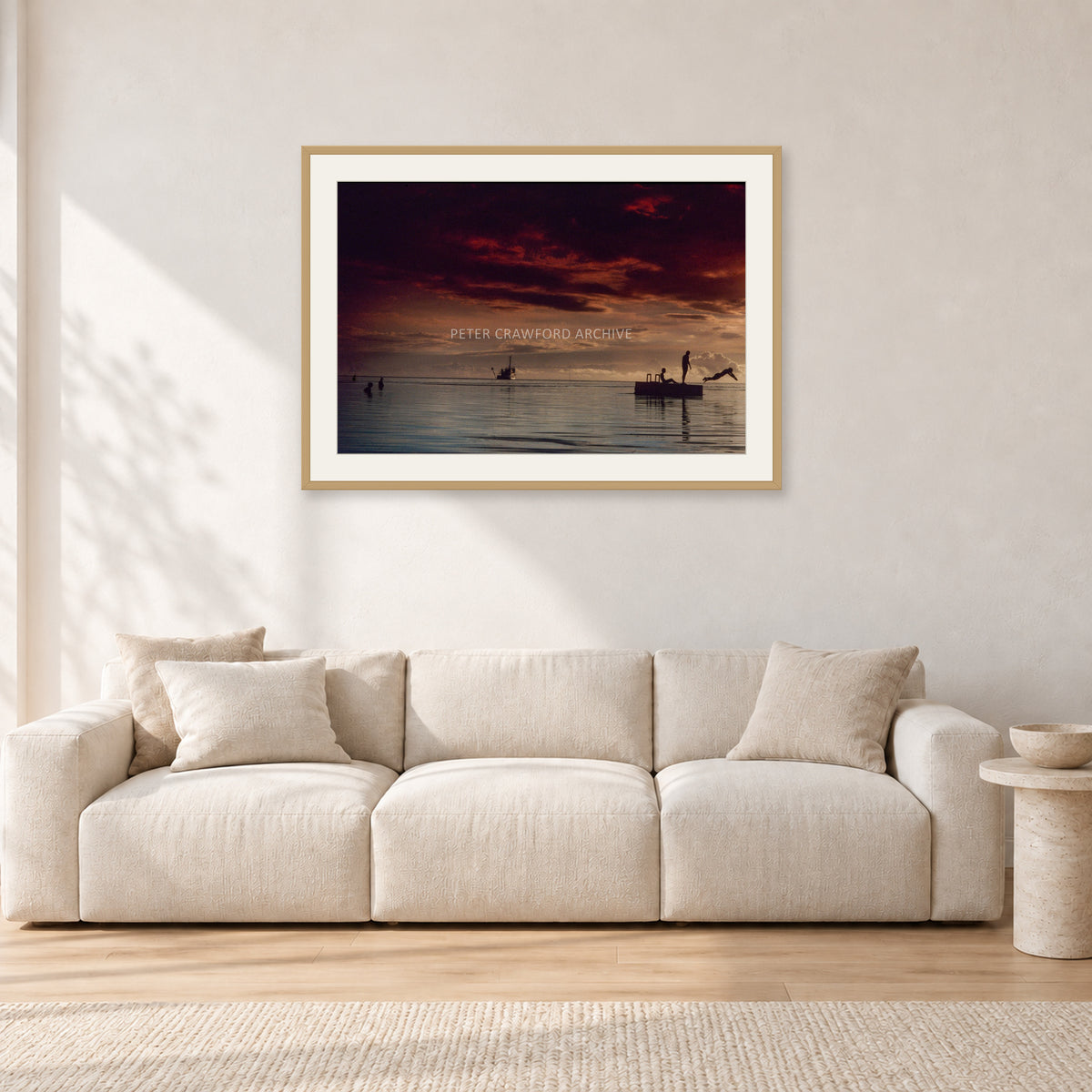 Fiji Sunset II by Peter Crawford — 90 × 60 cm, hayseed frame with white mat, shown in a light minimalist living room.