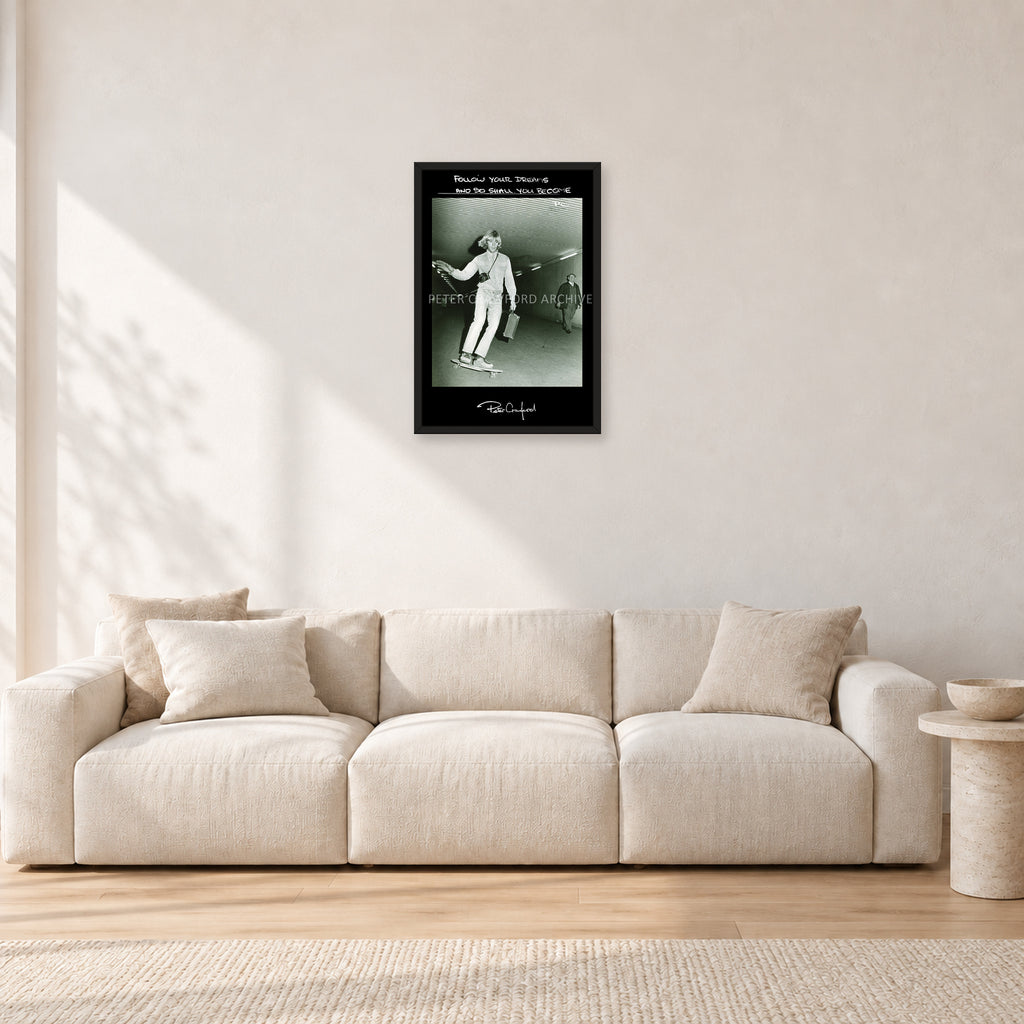 Follow Your Dreams by Peter Crawford — 40 × 60 cm, black frame, shown in a light minimalist living room.