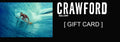Crawford Gallery gift card design with a surfer inside a blue wave and white gallery lettering on black.