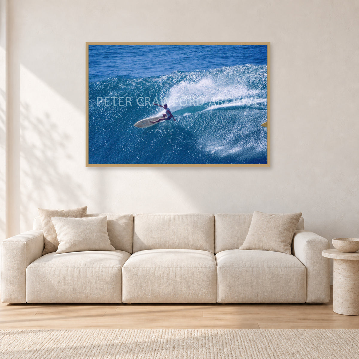 Honolua Bay, No Leash by Peter Crawford — 120 × 80 cm, hayseed frame, shown in a light minimalist living room.