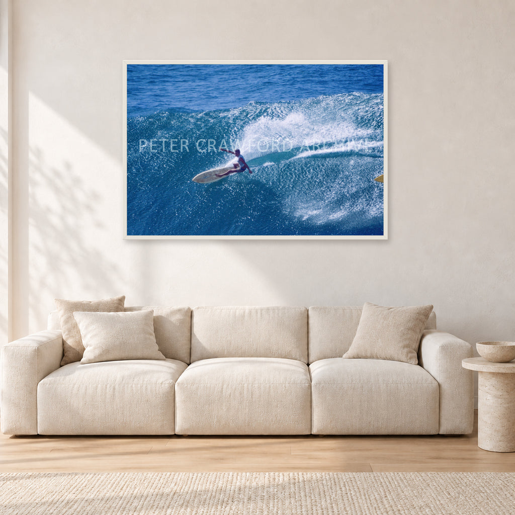 Honolua Bay, No Leash by Peter Crawford — 120 × 80 cm, white frame, shown in a light minimalist living room.