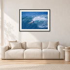 Honolua Bay, No Leash by Peter Crawford — 90 × 60 cm, black frame with white mat, shown in a light minimalist living room.