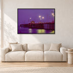 Huntington Pier by Peter Crawford — 120 × 80 cm, black frame, shown in a light minimalist living room.