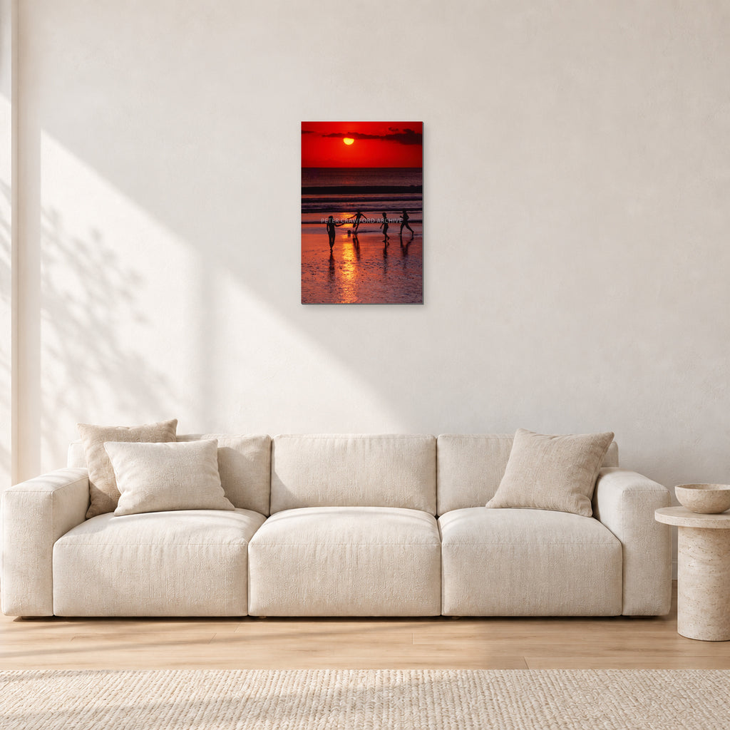 Indonesian Sunset Kids by Peter Crawford — 40 × 60 cm, aluminium-mounted resin print, shown in a light minimalist living room.