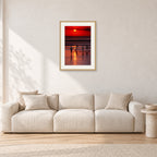 Indonesian Sunset Kids by Peter Crawford — 40 × 60 cm, hayseed frame with white mat, shown in a light minimalist living room.