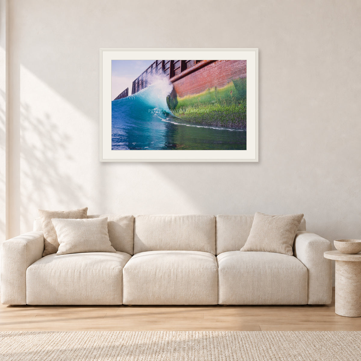 Indonesian Wreck, 1999 by Peter Crawford — 90 × 60 cm, white frame with white mat, shown in a light minimalist living room.