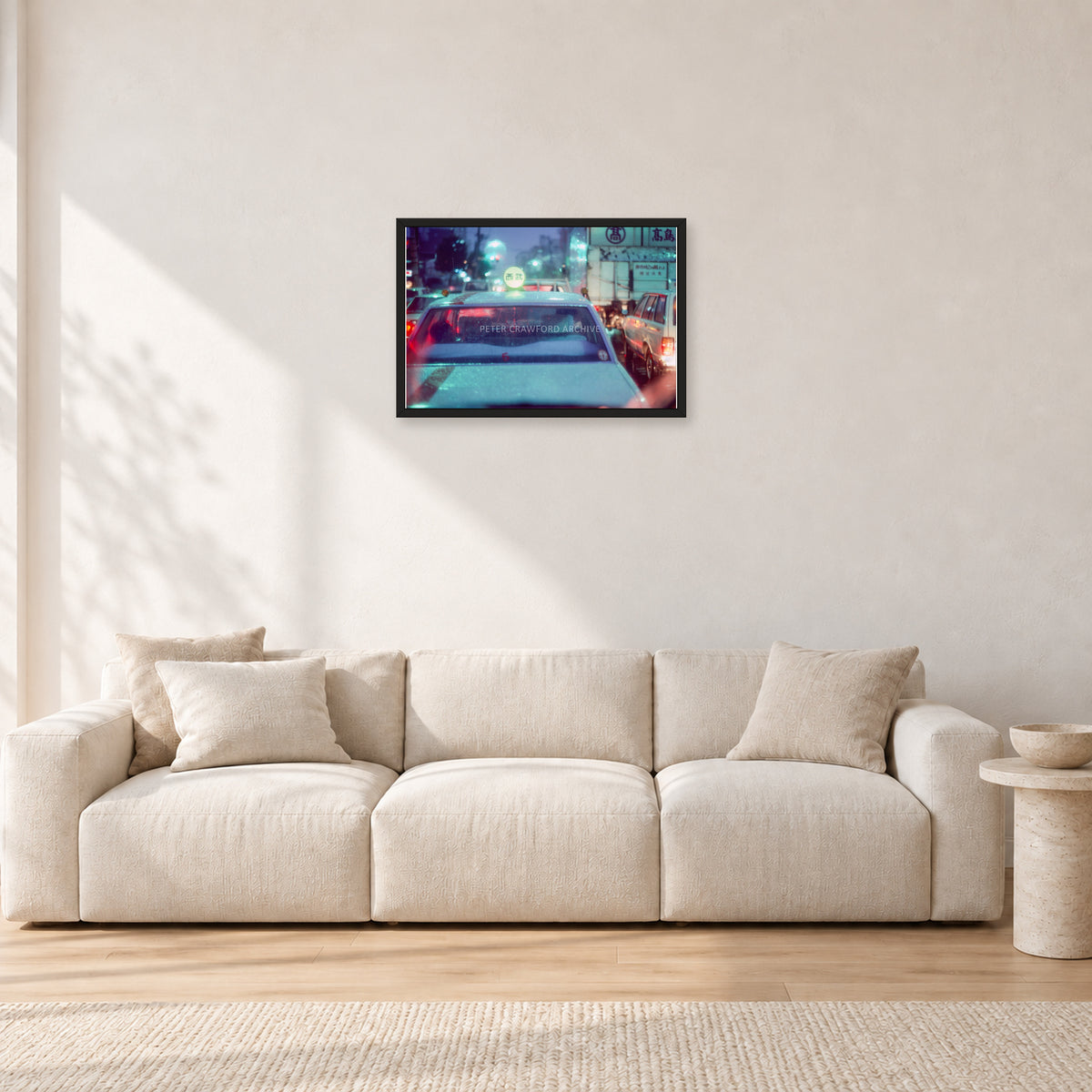 Japan City Lights by Peter Crawford — 60 × 40 cm, black frame, shown in a light minimalist living room.