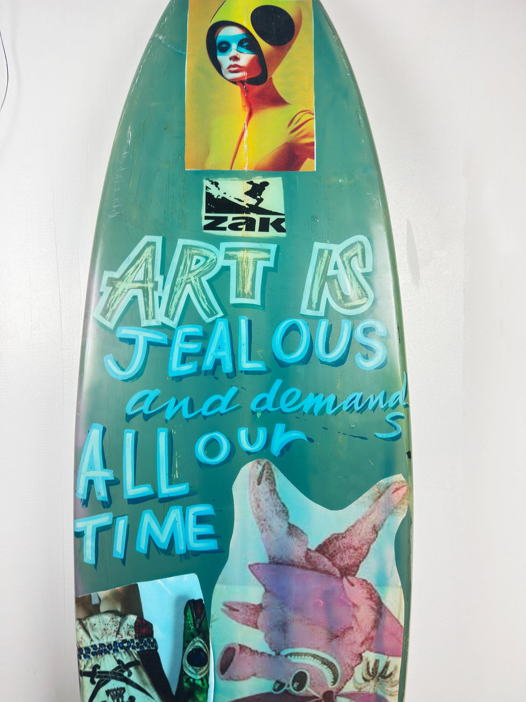 Blue Skulls Surfboard by David Bromley — central hand-painted lettering detail.