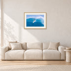 Kong, Sunset Beach 1980s by Peter Crawford — 60 × 40 cm, hayseed frame with white mat, shown in a light minimalist living room.