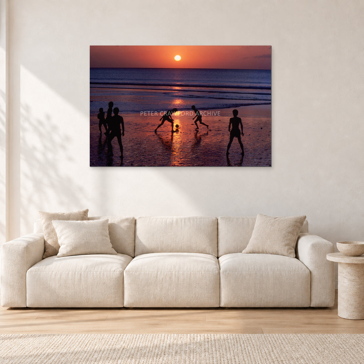 Kuta Kids Soccer, 1979 by Peter Crawford — 120 × 80 cm, aluminium-mounted resin print, shown in a light minimalist living room.