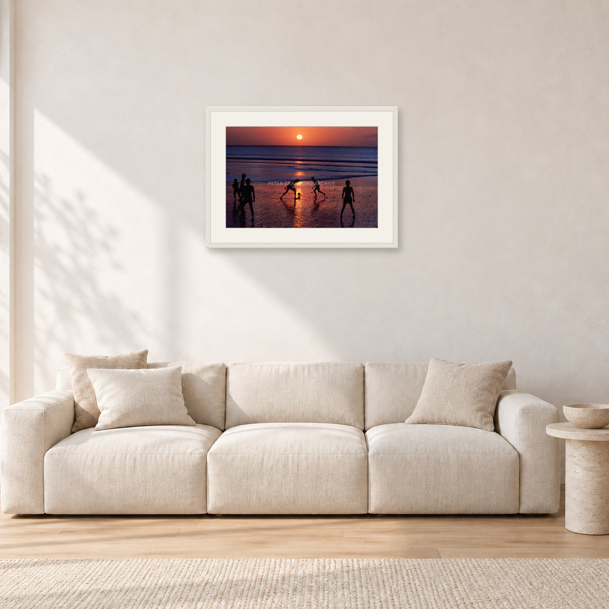 Kuta Kids Soccer, 1979 by Peter Crawford — 60 × 40 cm, white frame with white mat, shown in a light minimalist living room.