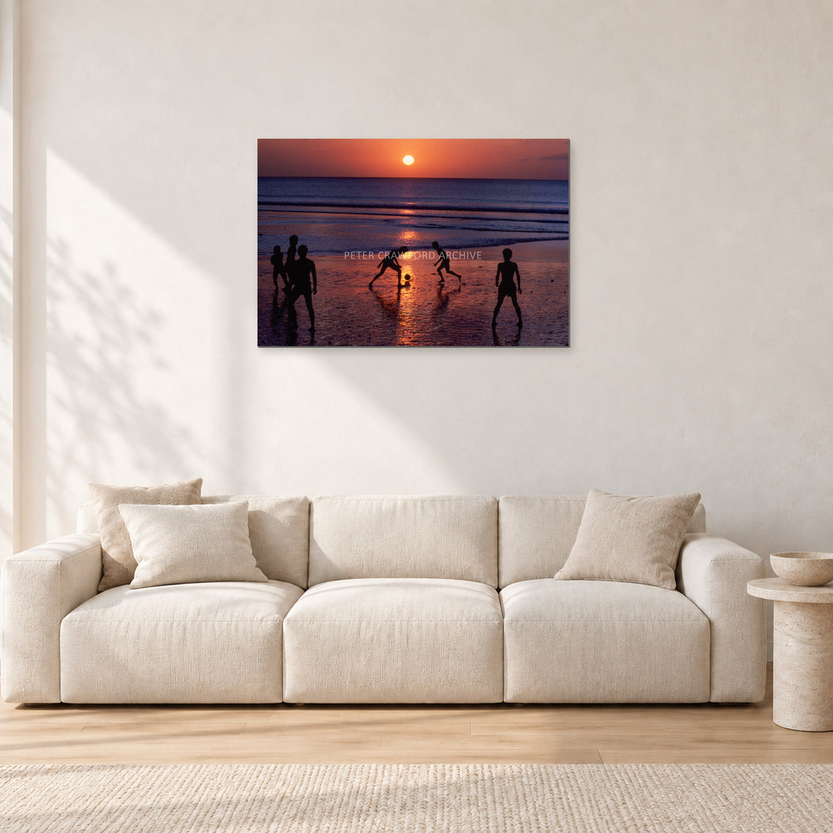 Kuta Kids Soccer, 1979 by Peter Crawford — 90 × 60 cm, aluminium-mounted resin print, shown in a light minimalist living room.