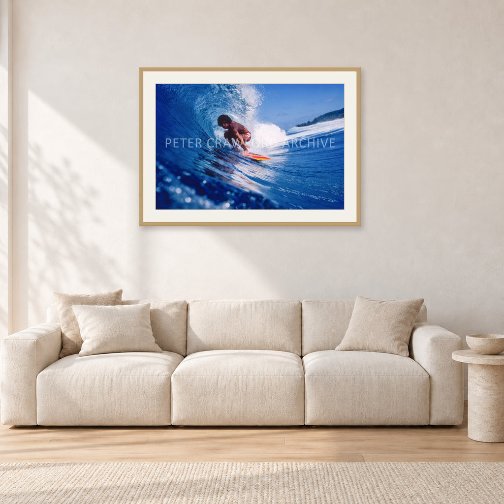 Larry Bertlemann, Off The Wall by Peter Crawford — 90 × 60 cm, hayseed frame with white mat, shown in a light minimalist living room.