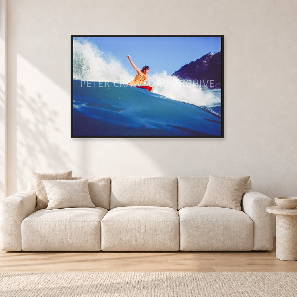 Mark Richards, Bells Beach 1979 by Peter Crawford — 120 × 80 cm, black frame, shown in a light minimalist living room.