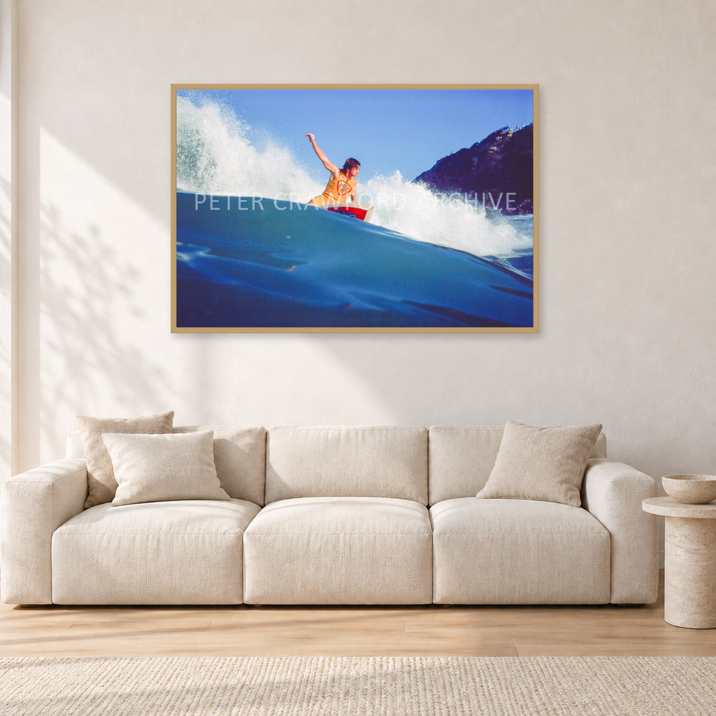 Mark Richards, Bells Beach 1979 by Peter Crawford — 120 × 80 cm, hayseed frame, shown in a light minimalist living room.