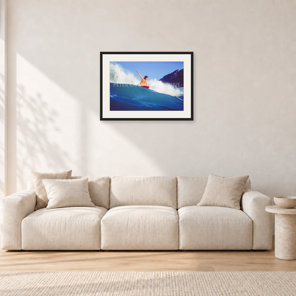 Mark Richards, Bells Beach 1979 by Peter Crawford — 60 × 40 cm, black frame with white mat, shown in a light minimalist living room.
