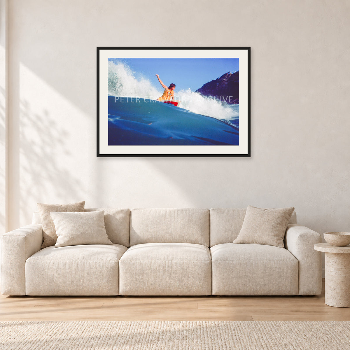 Mark Richards, Bells Beach 1979 by Peter Crawford — 90 × 60 cm, black frame with white mat, shown in a light minimalist living room.