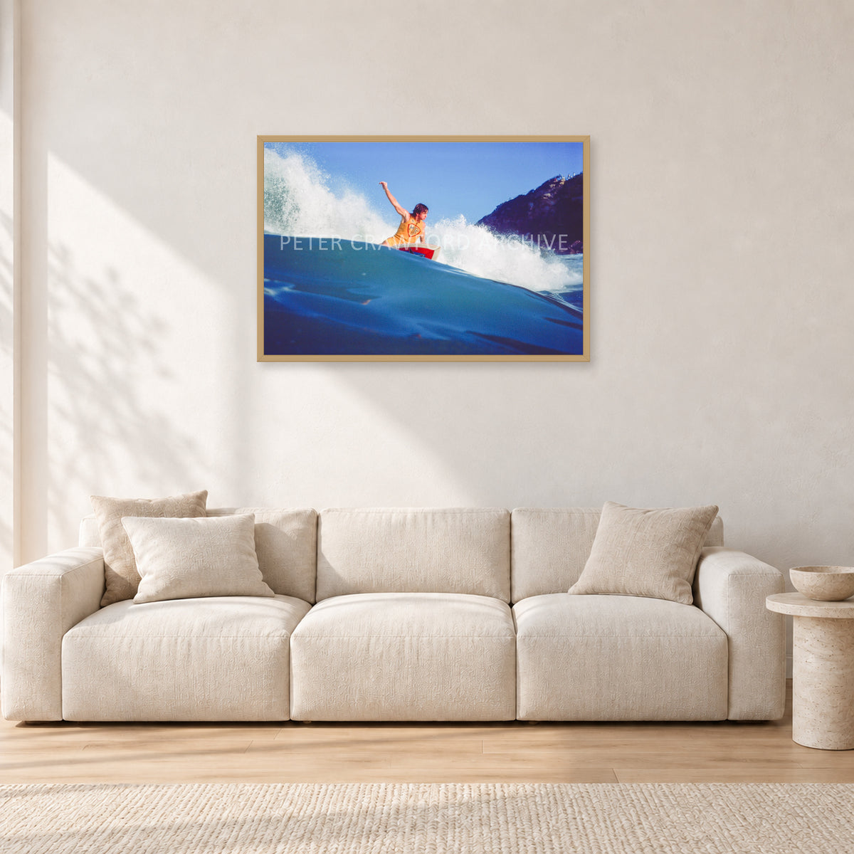 Mark Richards, Bells Beach 1979 by Peter Crawford — 90 × 60 cm, hayseed frame, shown in a light minimalist living room.