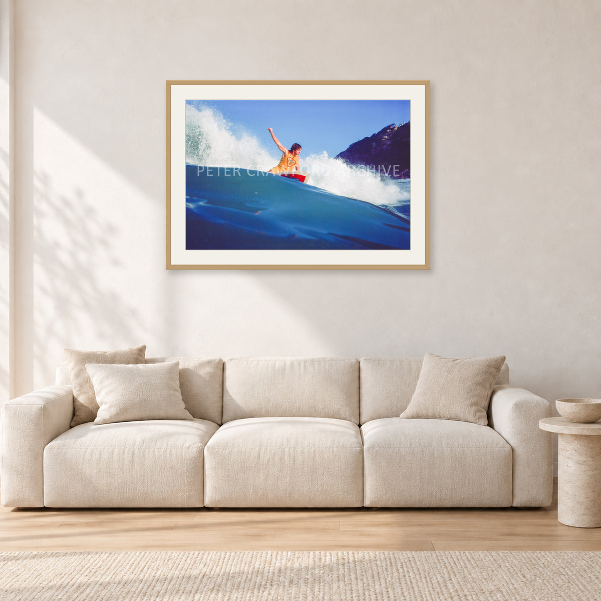 Mark Richards, Bells Beach 1979 by Peter Crawford — 90 × 60 cm, hayseed frame with white mat, shown in a light minimalist living room.