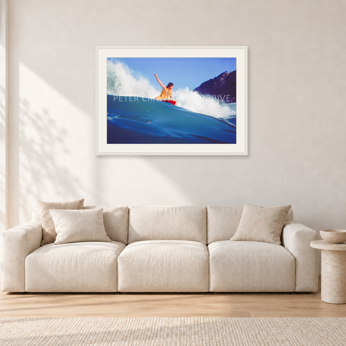 Mark Richards, Bells Beach 1979 by Peter Crawford — 90 × 60 cm, white frame with white mat, shown in a light minimalist living room.