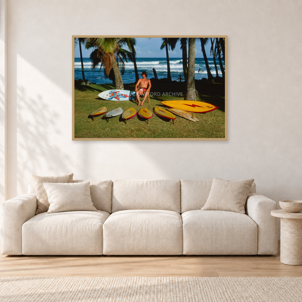Mark Richards Hawaiian Quiver, North Shore 1976 by Peter Crawford — 120 × 80 cm, hayseed frame, shown in a light minimalist living room.
