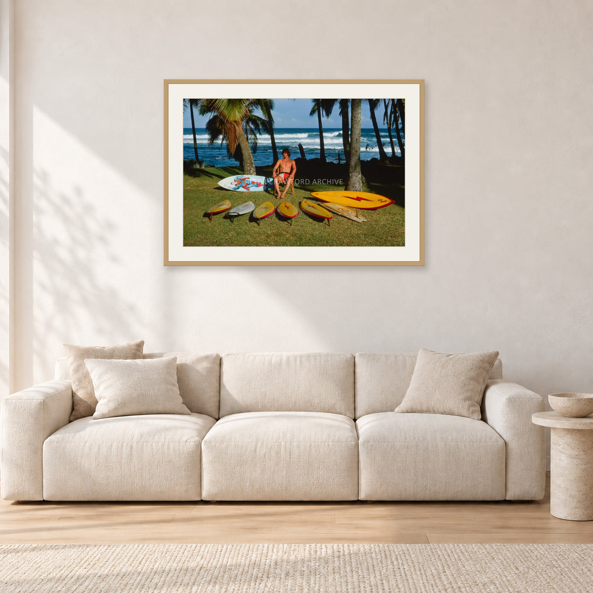 Mark Richards Hawaiian Quiver, North Shore 1976 by Peter Crawford — 90 × 60 cm, hayseed frame with white mat, shown in a light minimalist living room.