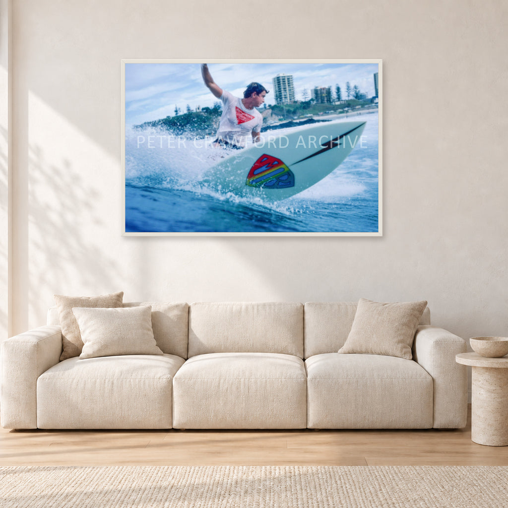 Mark Richards, Snapper Rocks by Peter Crawford — 120 × 80 cm, white frame, shown in a light minimalist living room.