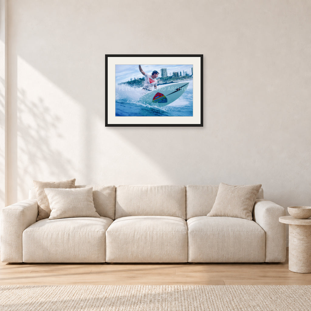 Mark Richards, Snapper Rocks by Peter Crawford — 60 × 40 cm, black frame with white mat, shown in a light minimalist living room.